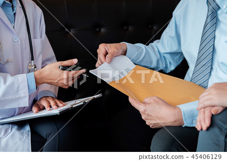 Patient listening intently to a male doctor 45406129