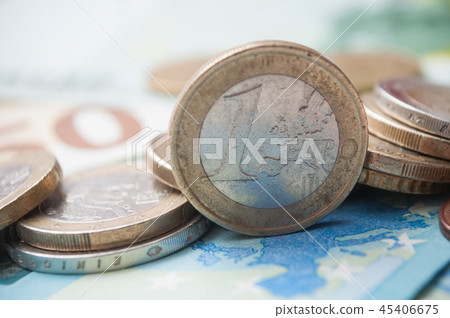 closeup of coins pile and banknotes in euro money closeup of coins pile and banknotes in euro money 45406675