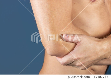 The man holds the elbow due to acute pain 45407714