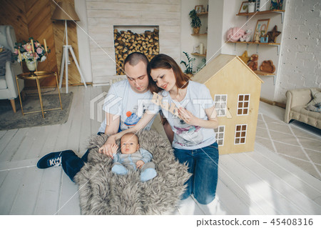 the baby on the hands of parents 45408316