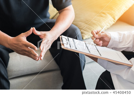 Doctor consulting male patient in hospital office 45408450