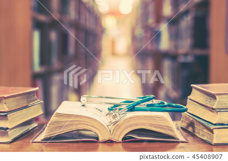 Old book in library with stethoscope on textbook Old book in library with stethoscope on textbook 45408907