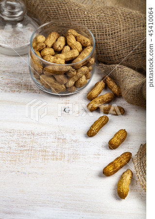 Peanuts in an open glass jar Peanuts in an open glass jar 45410064