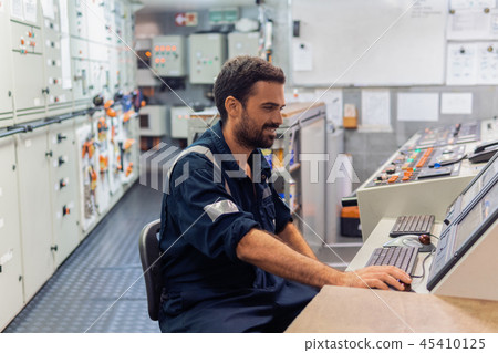 Marine engineer officer working in engine room Marine engineer officer working in engine room 45410125