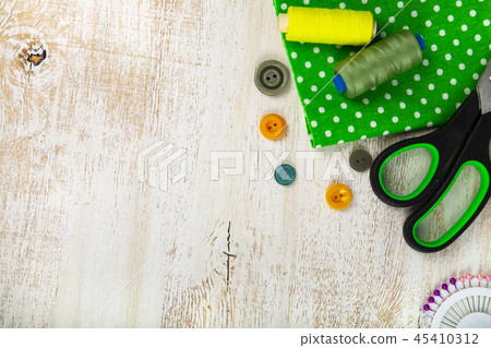 Sewing accessories and green fabric Sewing accessories and green fabric 45410312