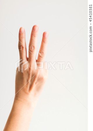 A hand showing three fingers for counting three. 45410381