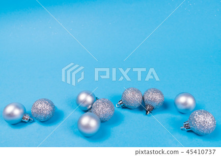 Many silver baubles on blue background. Many silver baubles on blue background. 45410737