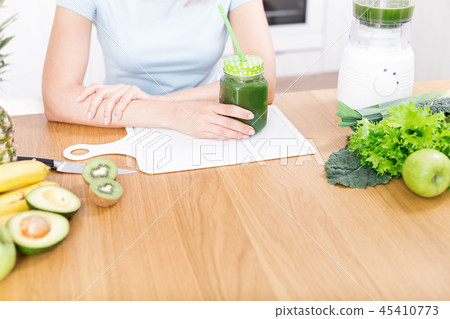 Preparing detox fruits smoothie in blender Preparing detox fruits smoothie in blender 45410773
