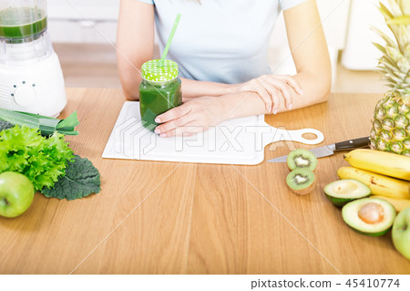 Preparing detox fruits smoothie in blender 45410774