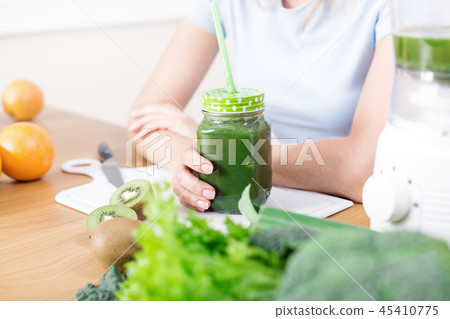 Preparing detox fruits smoothie in blender Preparing detox fruits smoothie in blender 45410775