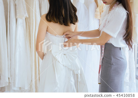 Asian bride trying on wedding dress 45410858