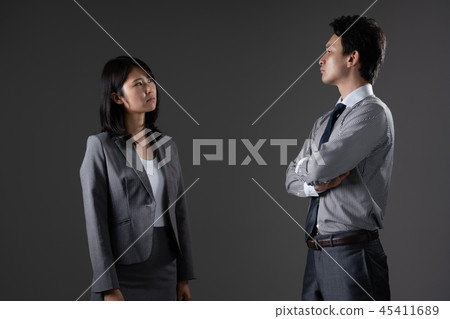 Opposing businessman and businesswoman 45411689