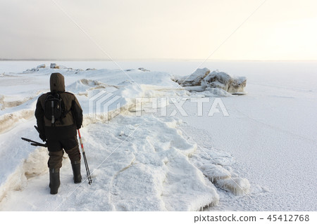 Man in walking on the a frozen Ob Reservoir,Russia 45412768