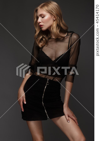 fashion model with long hair, perfect skin is posing in studio for glamour test photo shoot showing 45414170