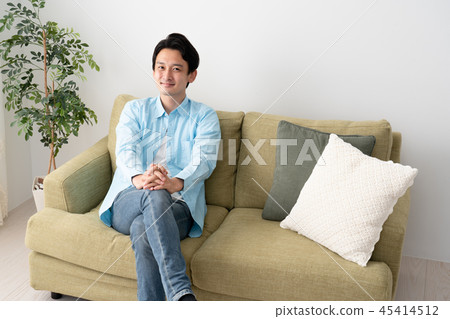 Young men with legs crossed Young men with legs crossed 45414512