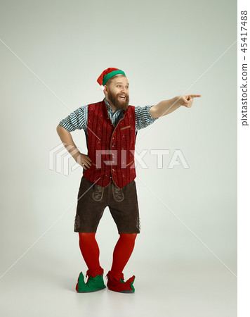 friendly man dressed like a funny gnome posing on an isolated gray background 45417488