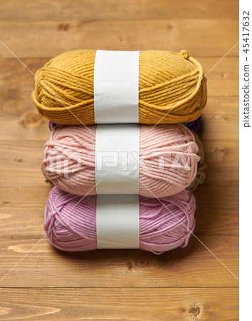 ball of wool yarn for knitting on wood background  45417632
