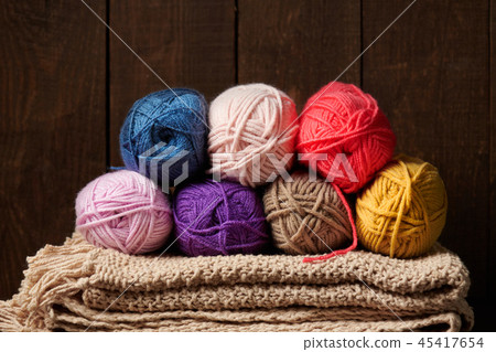 ball of wool yarn for knitting on wood background  45417654