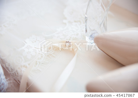 beautiful wedding accessories. Bride shoes, perfumes on a white veil beautiful wedding accessories. Bride shoes, perfumes on a white veil 45417867