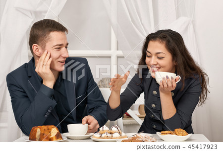romantic couple drinking tea with cookies, talking romantic couple drinking tea with cookies, talking 45417923