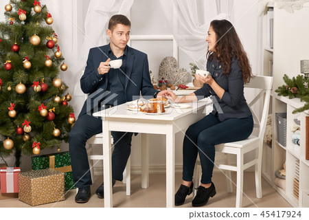 romantic couple drinking tea with cookies, talking romantic couple drinking tea with cookies, talking 45417924