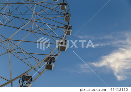 Very large Ferris wheel against the blue sky. Very large Ferris wheel against the blue sky. 45418110