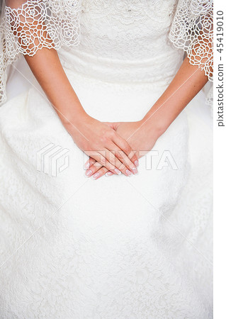 Bride hand on wedding dress with a nice manicure Bride hand on wedding dress with a nice manicure 45419010