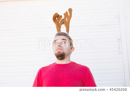 Holiday, Christmas and people concept - Surprised man in Christmas costume over white background 45420208