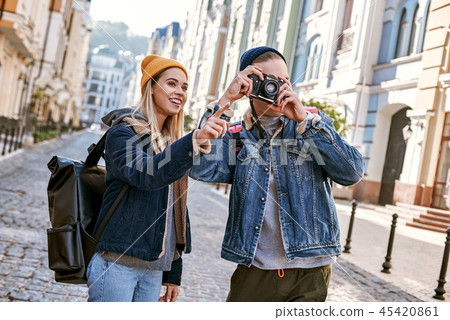 Young couple of travel bloggers are trying to take a photo in unfamiliar city 45420861