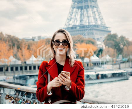 girl in red coat make a photo on parisian street girl in red coat make a photo on parisian street 45421019