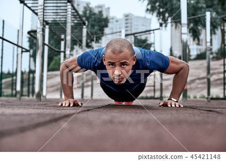 African man is doing plank at open air gym near the park African man is doing plank at open air gym near the park 45421148