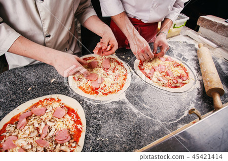A dough for a pizza in the hands of the chef. 45421414