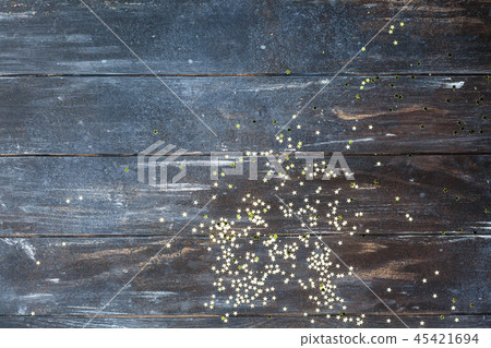 Dark wooden background with golden confetti Dark wooden background with golden confetti 45421694