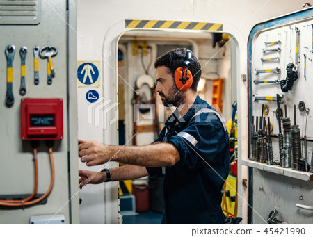 Marine engineer officer working in engine room Marine engineer officer working in engine room 45421990
