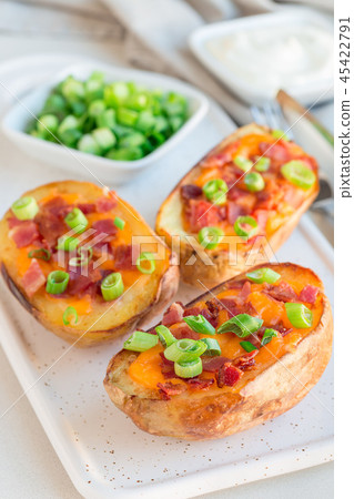 Baked potato skins with cheddar cheese and bacon Baked potato skins with cheddar cheese and bacon 45422791