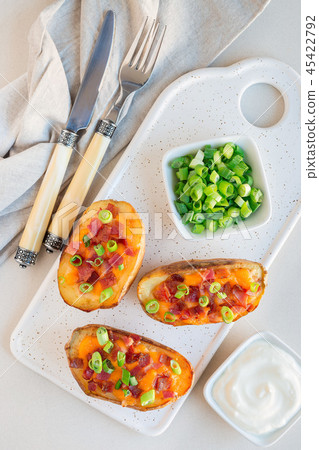 Baked potato skins with cheddar cheese and bacon Baked potato skins with cheddar cheese and bacon 45422792