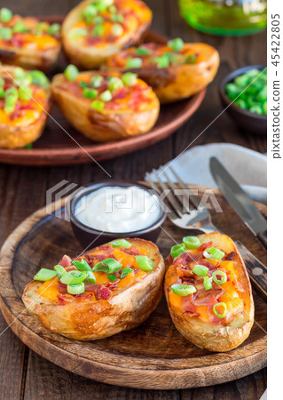 Baked potato skins with cheddar cheese and bacon Baked potato skins with cheddar cheese and bacon 45422805