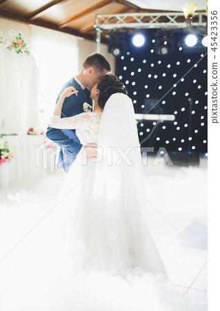 Beautiful wedding couple just married and dancing their first dance 45423356