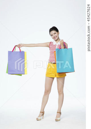 beautiful young woman shopping, sale concept photo. attractive young woman isolated. 096 45427624