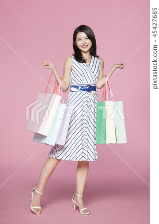 beautiful young woman shopping, sale concept photo. attractive young woman isolated. 054 45427685