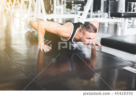 Strong man doing push up and exercises on floor Strong man doing push up and exercises on floor 45428350