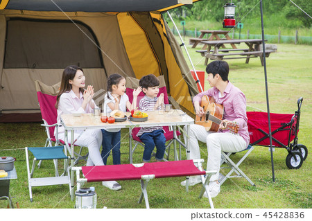 Family Having Picnic Outdoors Pas With Two Stock Photo