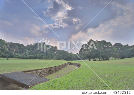 Green golf course cart path in cloudy Green golf course cart path in cloudy 45432512
