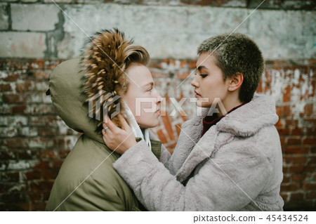 a girl holds a guy in the hood 45434524