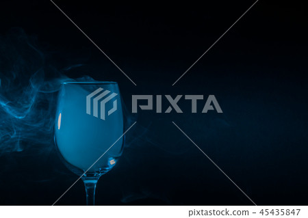 Wine glass filled with smoke on a black background Wine glass filled with smoke on a black background 45435847
