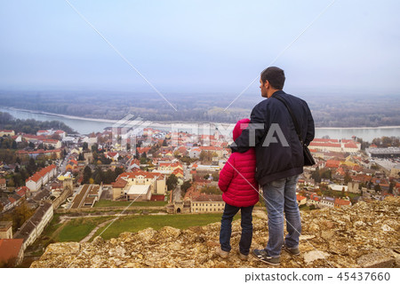 A man and a child look down on the city 45437660