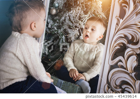 surprised boy sitting in front of the mirror surprised boy sitting in front of the mirror 45439614