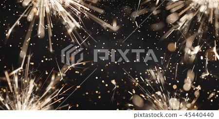 Burning christmas sparklers and smoke on dark background Burning christmas sparklers and smoke on dark background 45440440