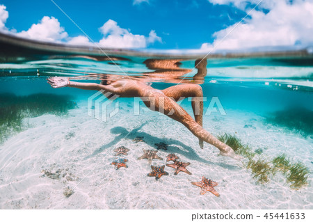 Beautiful woman floating and relax in tropical sea 45441633