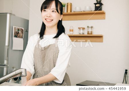 Young housewife washing utensils in kitchen 45441959